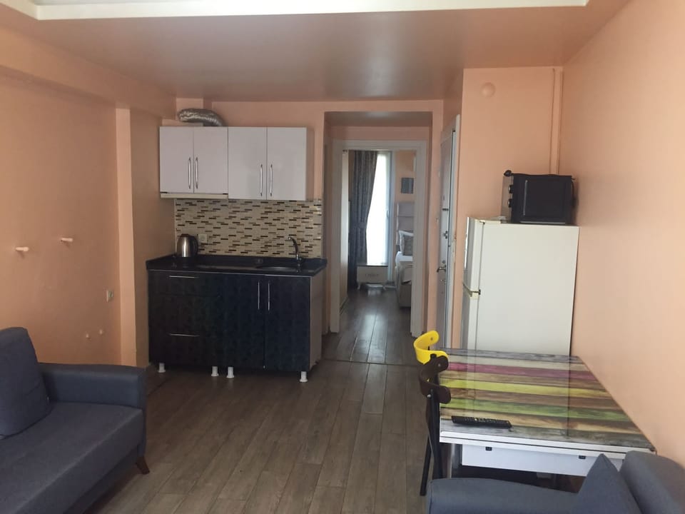 Junior Suite, 1 Bedroom, Kitchenette, City View | Living area | Flat-screen TV