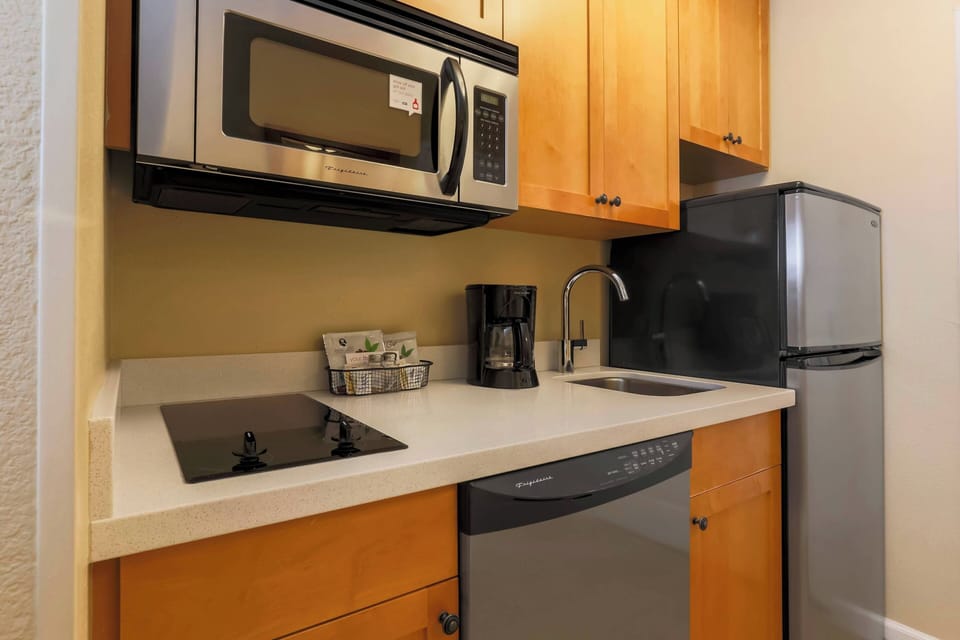 Studio, 1 Queen Bed | Private kitchen | Full-size fridge, microwave, stovetop, dishwasher
