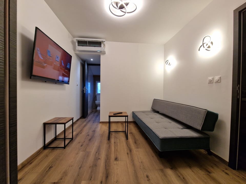 Family Apartment, 3 Bedrooms | Living area | 32-inch flat-screen TV with digital channels