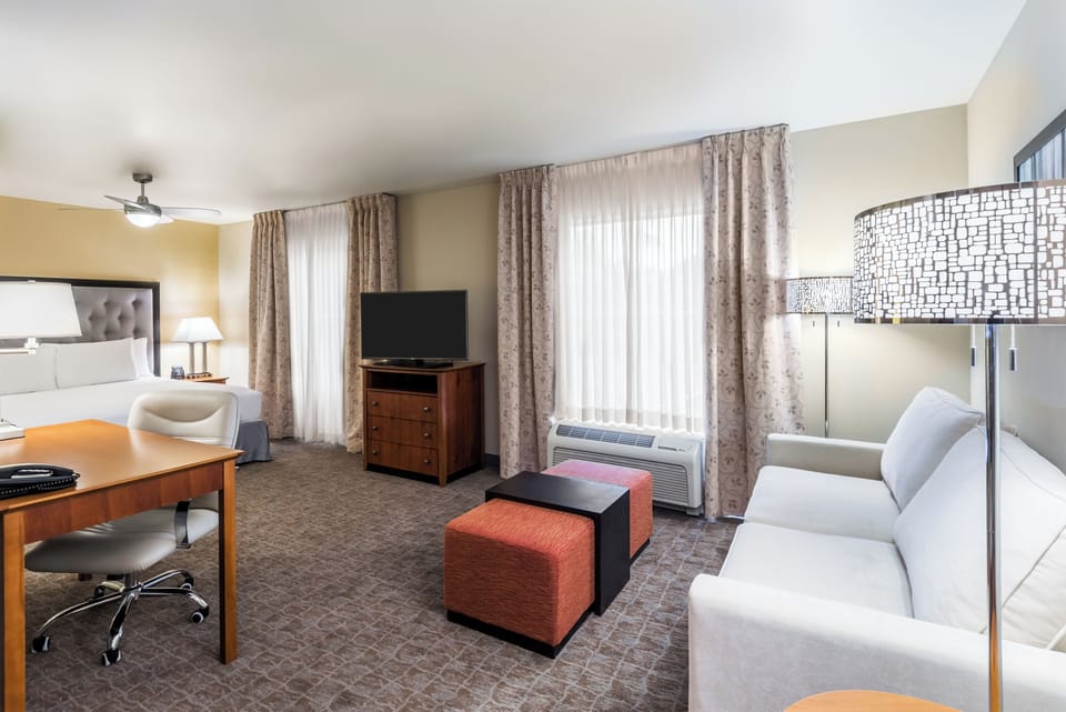 Premium bedding, desk, laptop workspace, blackout drapes