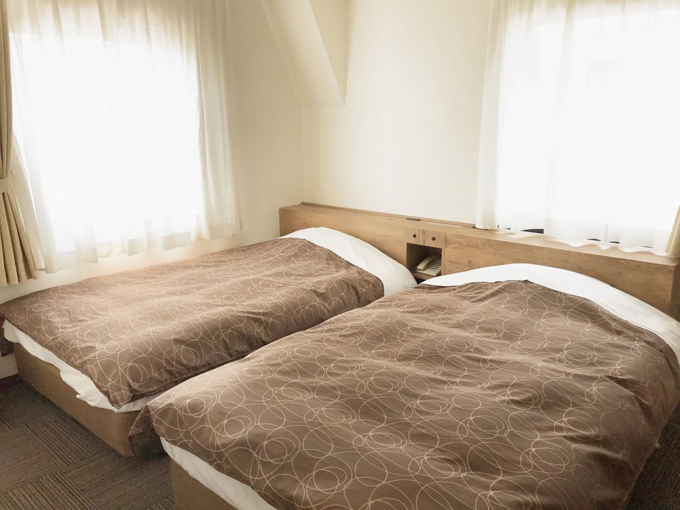 Twin Room, Non Smoking | Desk, blackout drapes, iron/ironing board, free wired internet