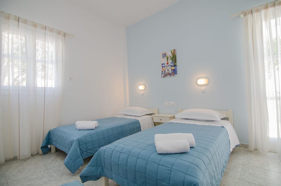 Triple Room, Garden View | In-room safe, desk, laptop workspace, blackout drapes