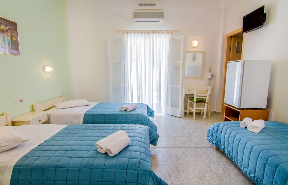 Triple Room, Garden View | In-room safe, desk, laptop workspace, blackout drapes