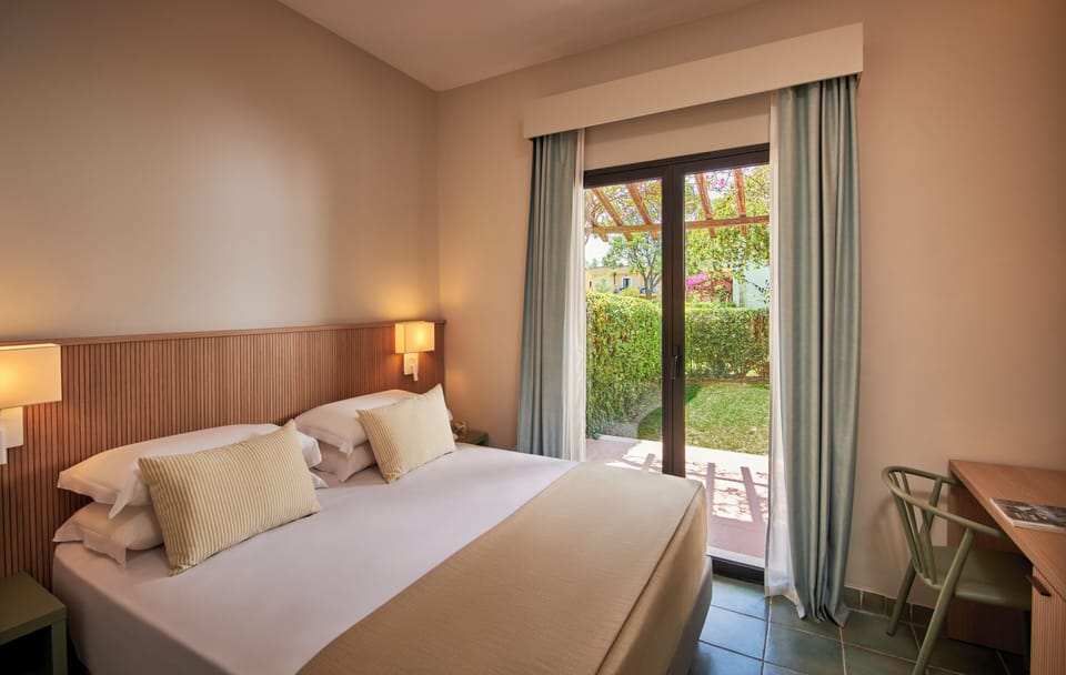 In-room safe, desk, laptop workspace, bed sheets