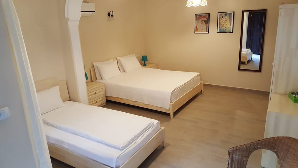 Triple Room, 1 Bedroom, Non Smoking, Garden View | Minibar, in-room safe, individually decorated, desk