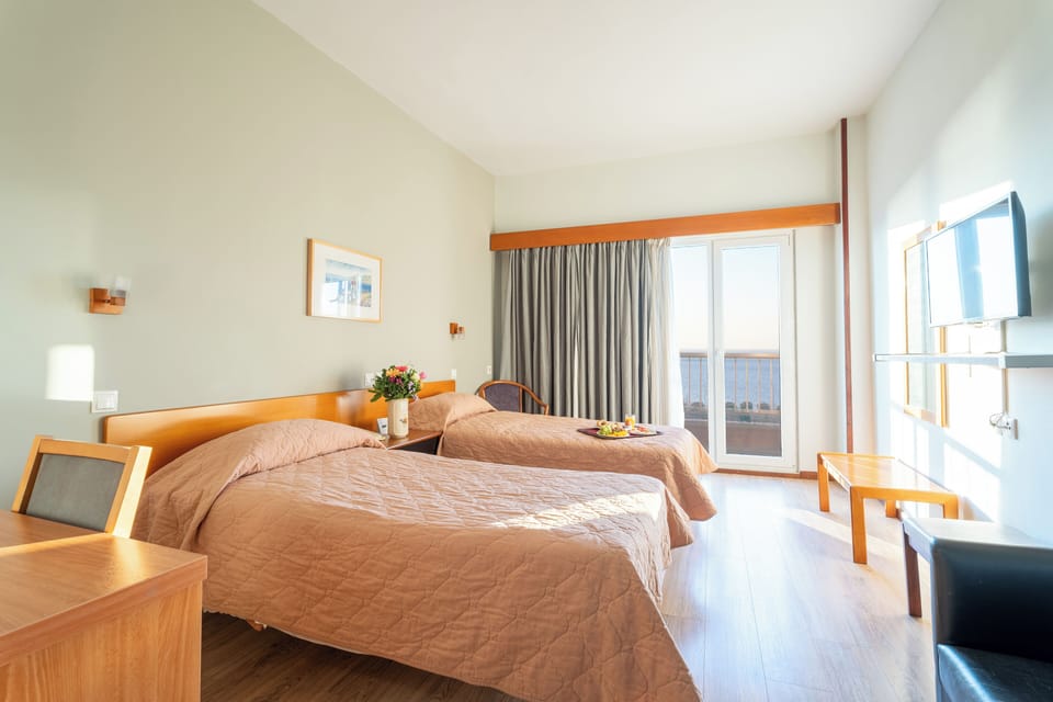 Twin Room, Balcony, Sea View | Minibar, in-room safe, desk, blackout drapes