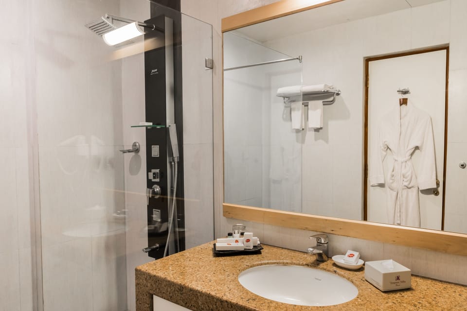 Suite, 1 King Bed | Bathroom | Shower, free toiletries, hair dryer, towels