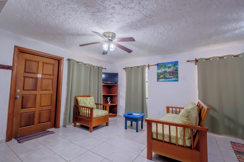 Luxury Condo, 1 Bedroom, Pool View, Garden Area | Living area | 32-inch Smart TV with cable channels, books
