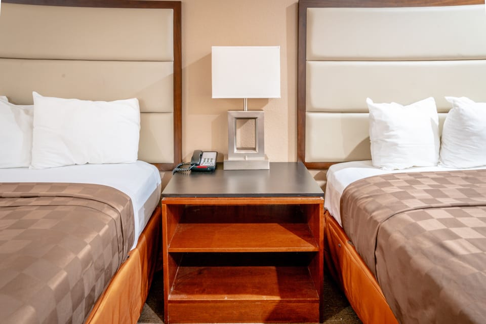 Deluxe Room, 2 Queen Beds | Iron/ironing board, WiFi (free), bed sheets