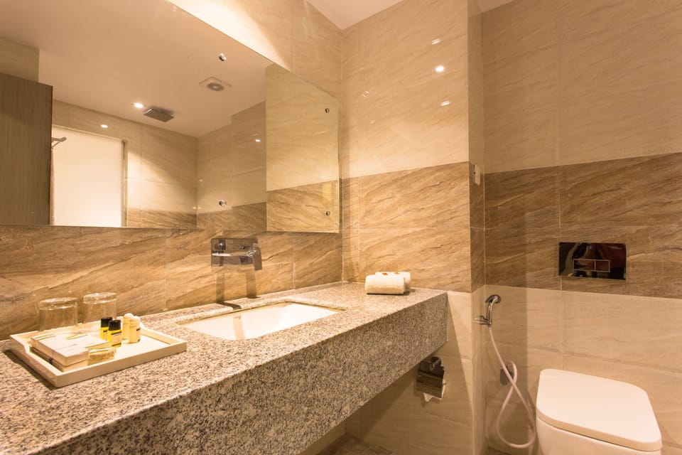 Deluxe Room, 1 Bedroom, City View | Bathroom | Shower, rainfall showerhead, hair dryer, bathrobes