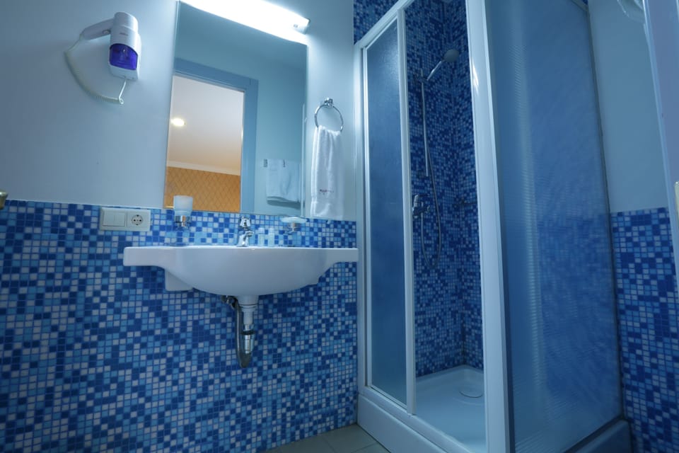 Shower, free toiletries, hair dryer, slippers