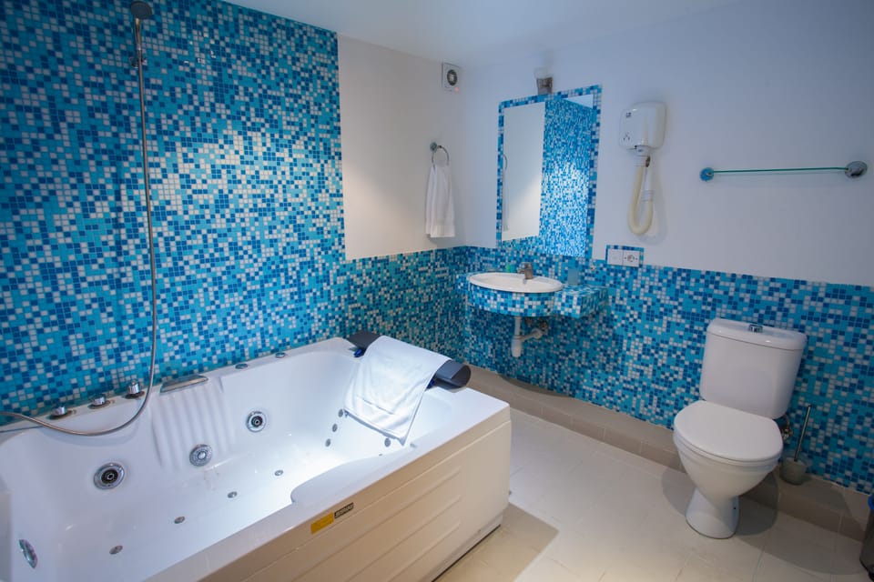 Superior Double Room, Jetted Tub (Building A) | Bathroom | Shower, free toiletries, hair dryer, slippers