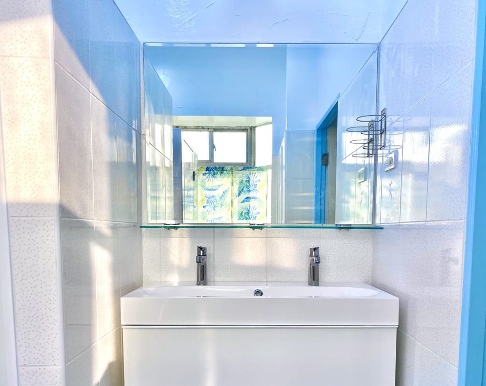 Shower, hair dryer, slippers, towels