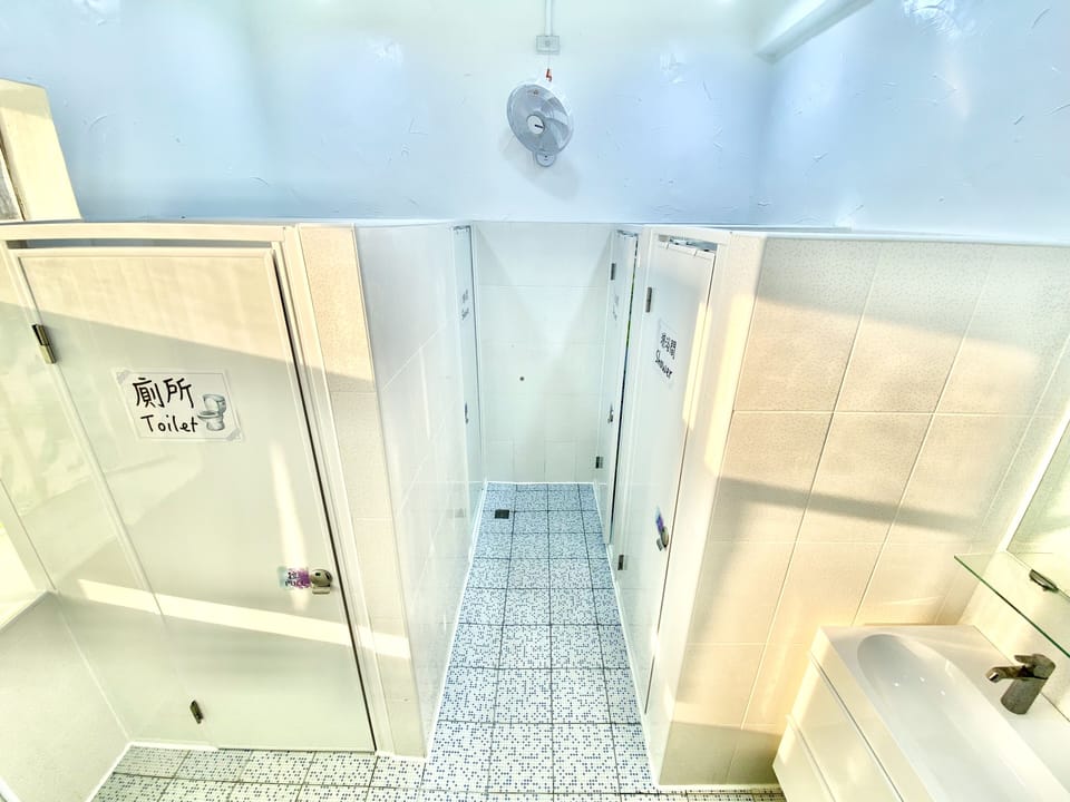 Shower, hair dryer, slippers, towels