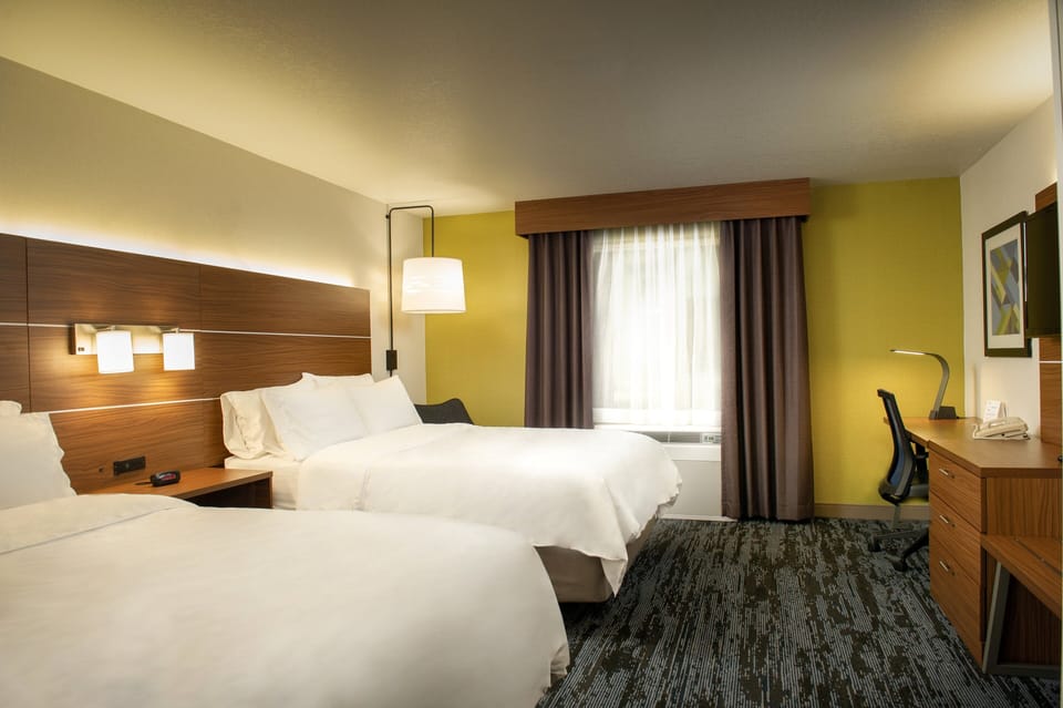 Premium bedding, desk, laptop workspace, blackout drapes