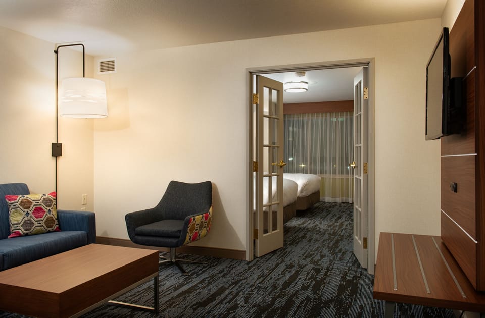 Premium bedding, desk, laptop workspace, blackout drapes