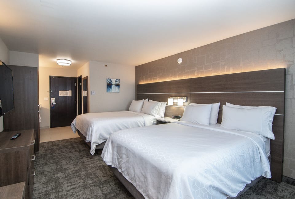 Premium bedding, desk, laptop workspace, blackout drapes