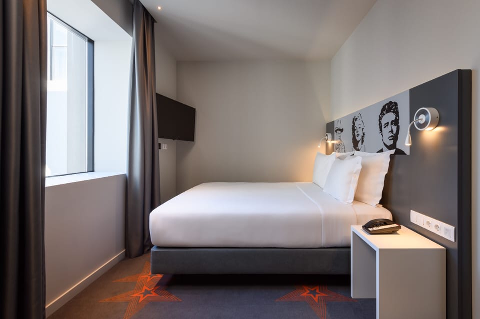 Standard Double Room | Minibar, in-room safe, desk, blackout drapes