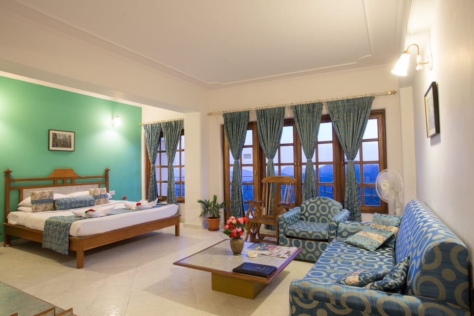 Royal Studio With Balcony and Valley View | Living area | 22-inch LCD TV with satellite channels, TV