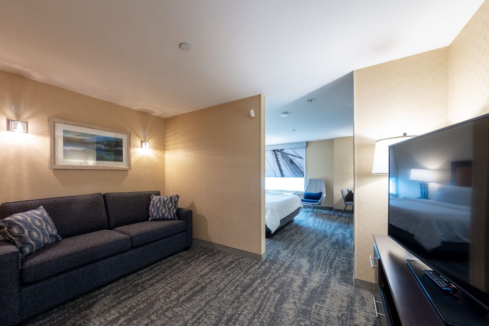 Suite, 1 King Bed with Sofa bed | Living room | 32-inch flat-screen TV with cable channels, TV