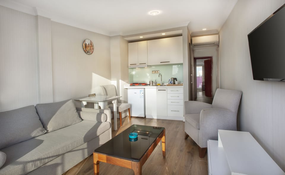 Deluxe Suite, 1 Bedroom, Lanai, Partial Sea View | Living area | 30-inch LCD TV with satellite channels, TV