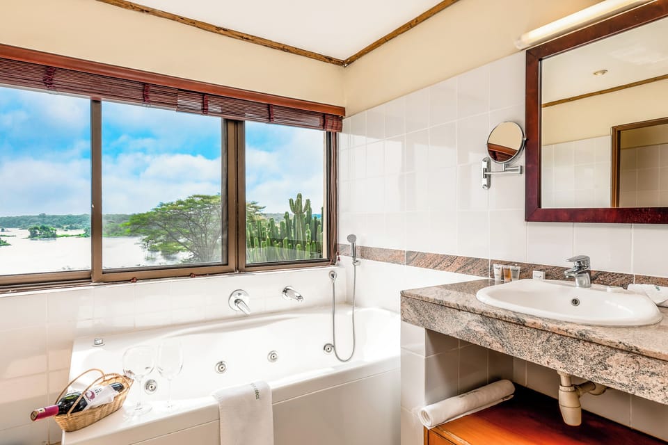 Signature Room | Bathroom | Separate tub and shower, deep soaking tub, rainfall showerhead