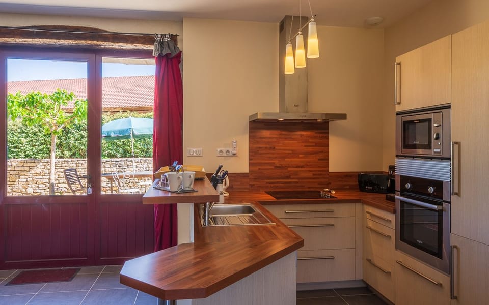 Superior House, Terrace (Gite Jeanne) | Private kitchen | Microwave, toaster, cleaning supplies, dining tables