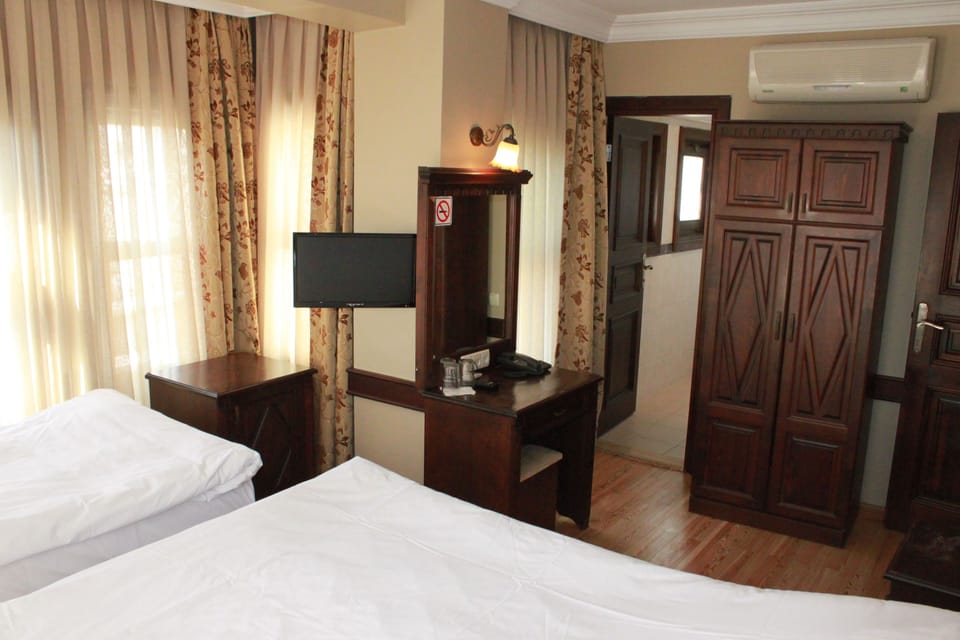 Standard Triple Room, City View | In-room safe, desk, blackout drapes, rollaway beds