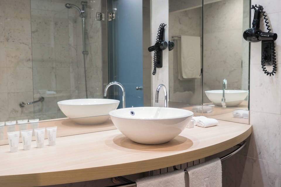 Designer toiletries, hair dryer, towels