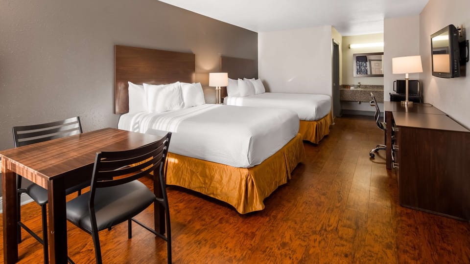 Premium bedding, desk, laptop workspace, blackout drapes