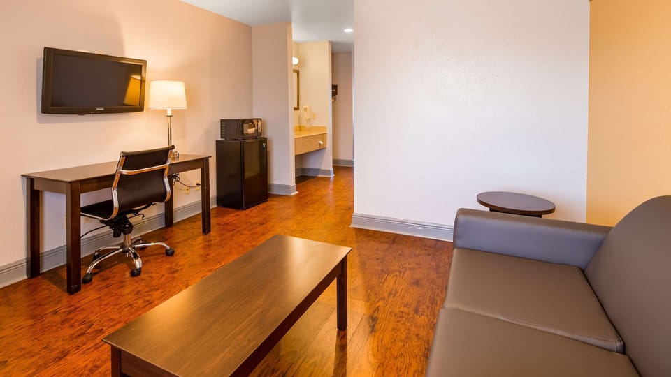Premium bedding, desk, laptop workspace, blackout drapes