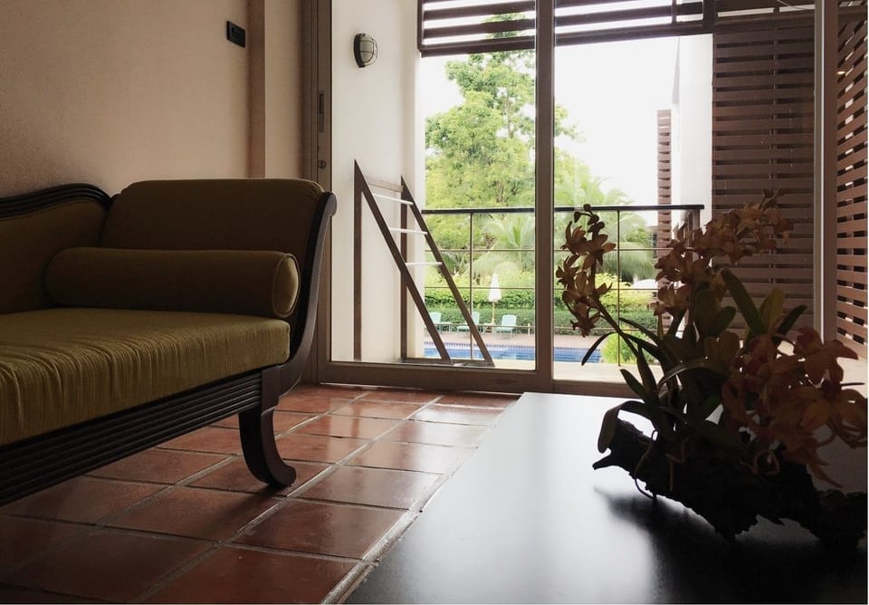 Junior Suite, Pool View | Living area | TV