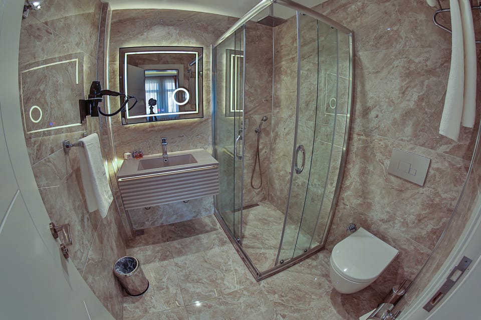 Classic Triple Room, Sea View | Bathroom | Shower, rainfall showerhead, free toiletries, hair dryer