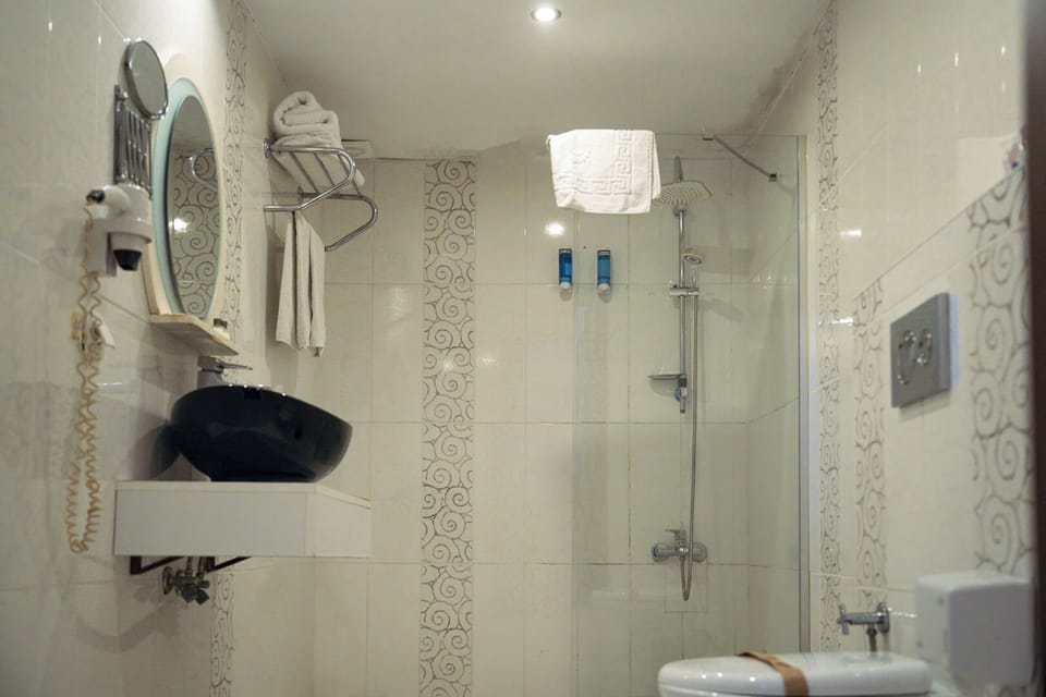 Shower, free toiletries, hair dryer, slippers
