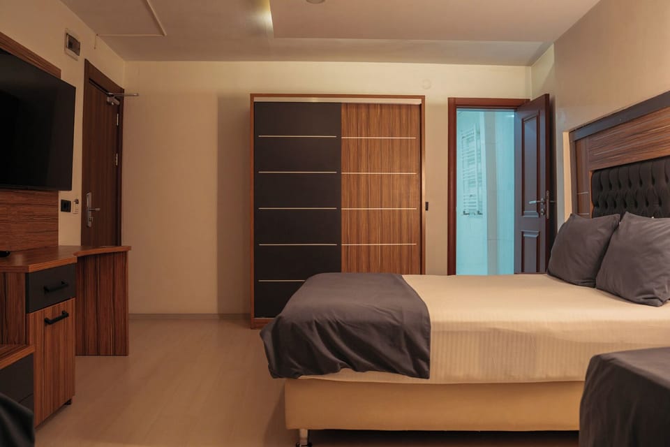 Family Quadruple Room | Minibar, desk, laptop workspace, blackout drapes