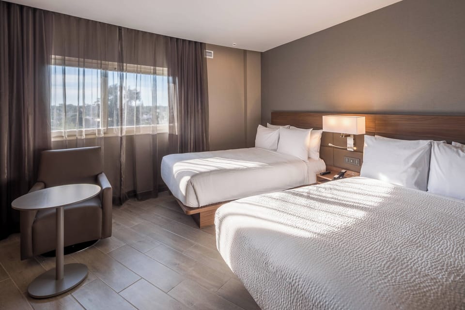 Room, 2 Double Beds, City View | In-room safe, desk, laptop workspace, blackout drapes