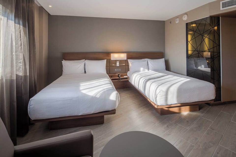 Room, 2 Double Beds, City View | In-room safe, desk, laptop workspace, blackout drapes