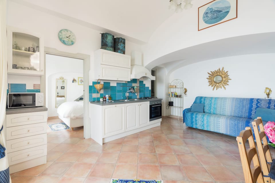 Panoramic Apartment, 2 Bedrooms, Jetted Tub, Sea View (L'Infinito) | Living area | Flat-screen TV
