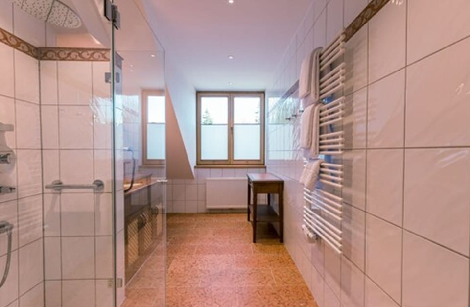 Junior Suite, 1 Bedroom (Single Use) | Bathroom | Rainfall showerhead, free toiletries, hair dryer, towels