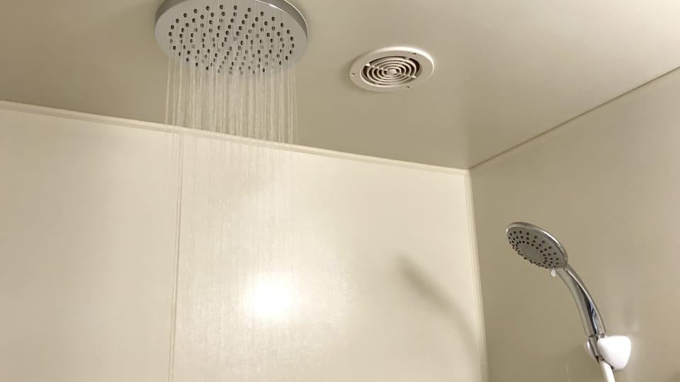 Combined shower/tub, free toiletries, hair dryer, slippers