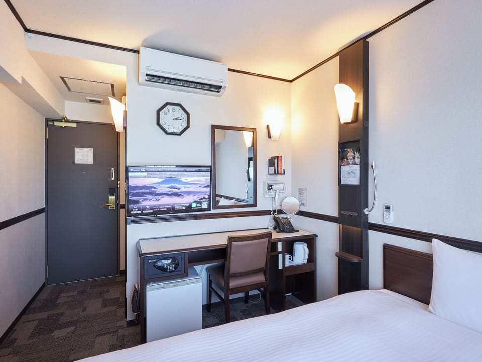 Desk, laptop workspace, bed sheets