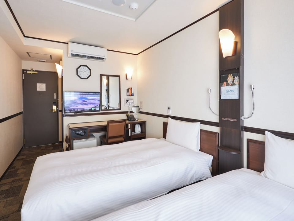 Desk, laptop workspace, bed sheets