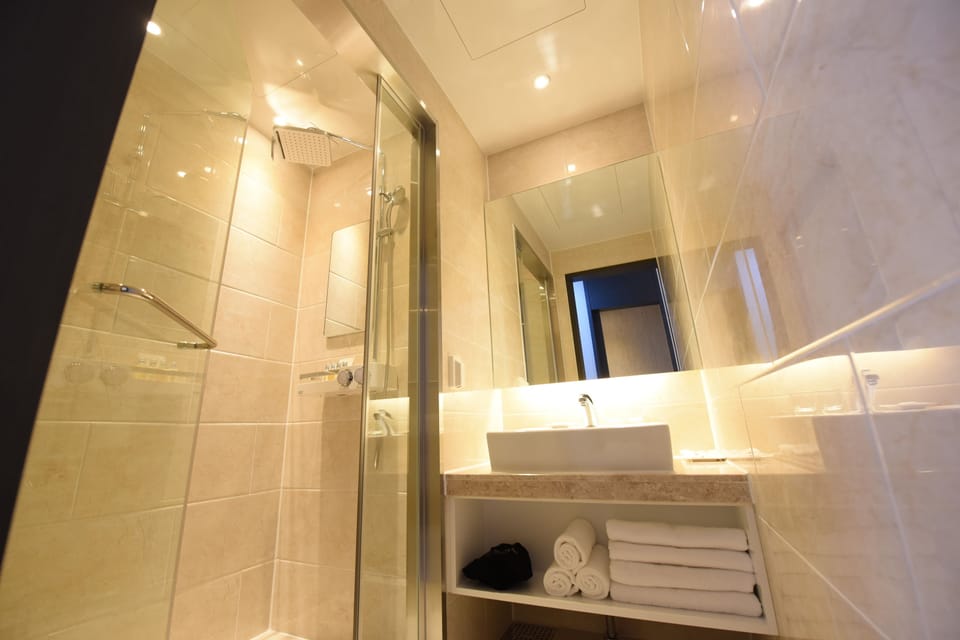 Shower, designer toiletries, hair dryer, bathrobes