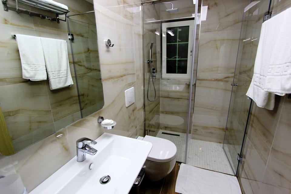 Shower, free toiletries, slippers, towels