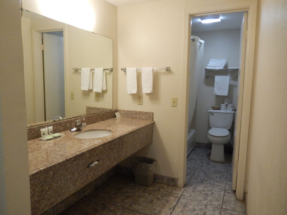 Standard Room, 2 Queen Beds | Bathroom | Combined shower/tub, free toiletries, hair dryer, towels