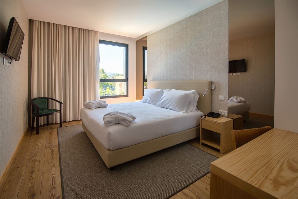 Standard Double Room | Minibar, in-room safe, desk, blackout drapes