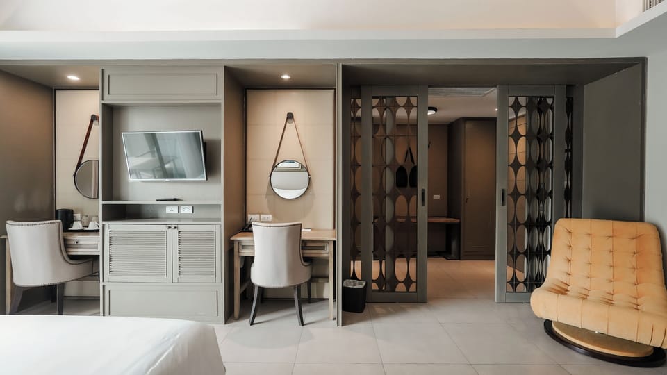 One Bedroom Suite | Living area | 32-inch flat-screen TV with cable channels, TV