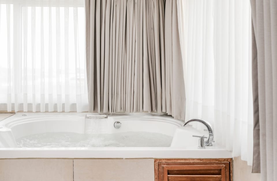 Suite, 1 King Bed, Non Smoking | Bathroom | Combined shower/tub, deep soaking tub, rainfall showerhead