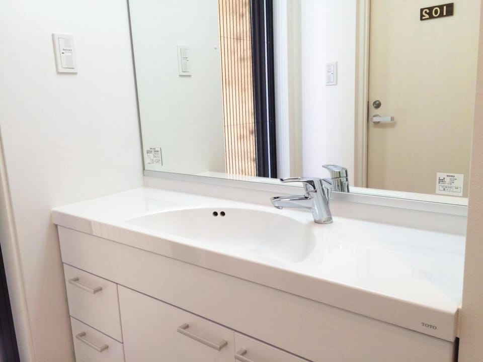 Shower, hair dryer, slippers, towels