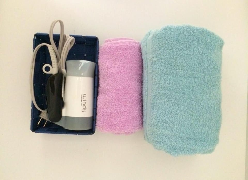 Shower, hair dryer, slippers, towels